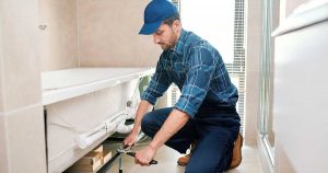 Hardy Plumbing service technician installing bathtub